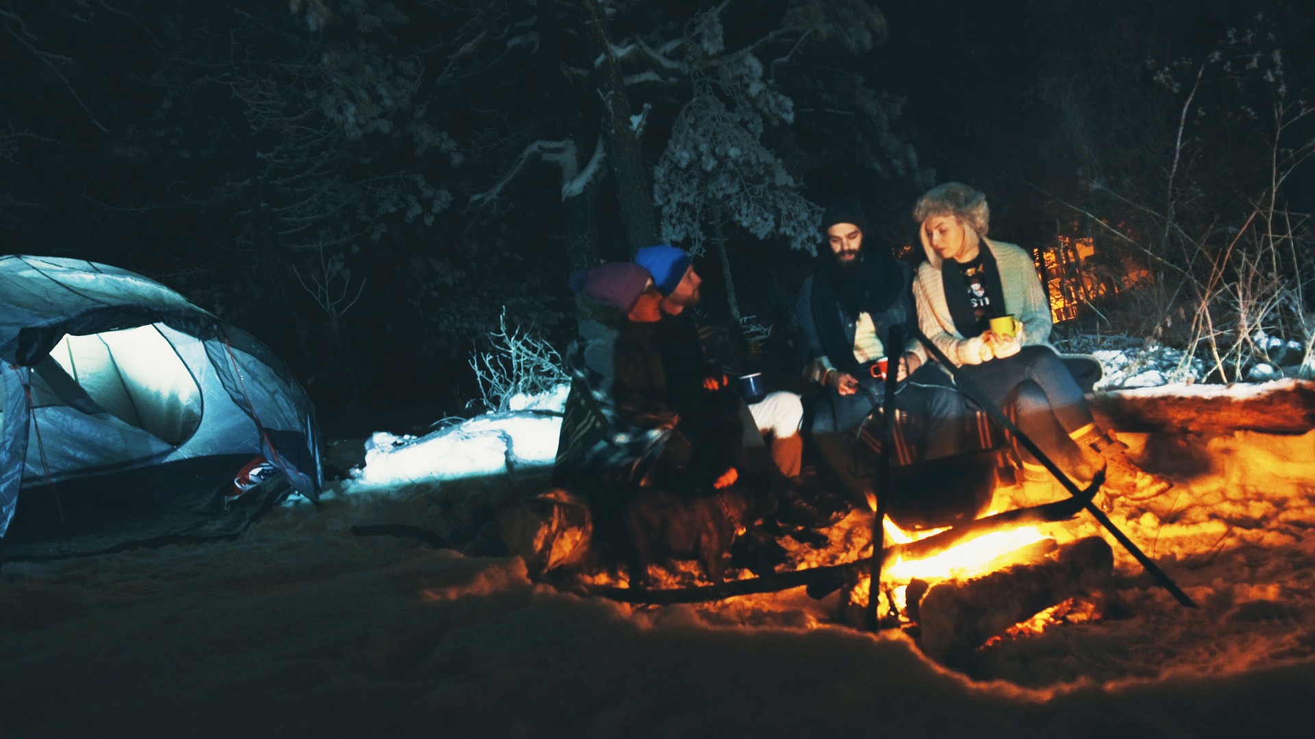 Four hipsters camping on mountain